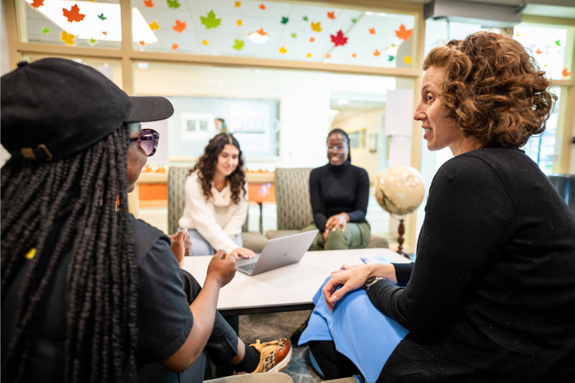 Students receive advising services inside the Padnos International Center.